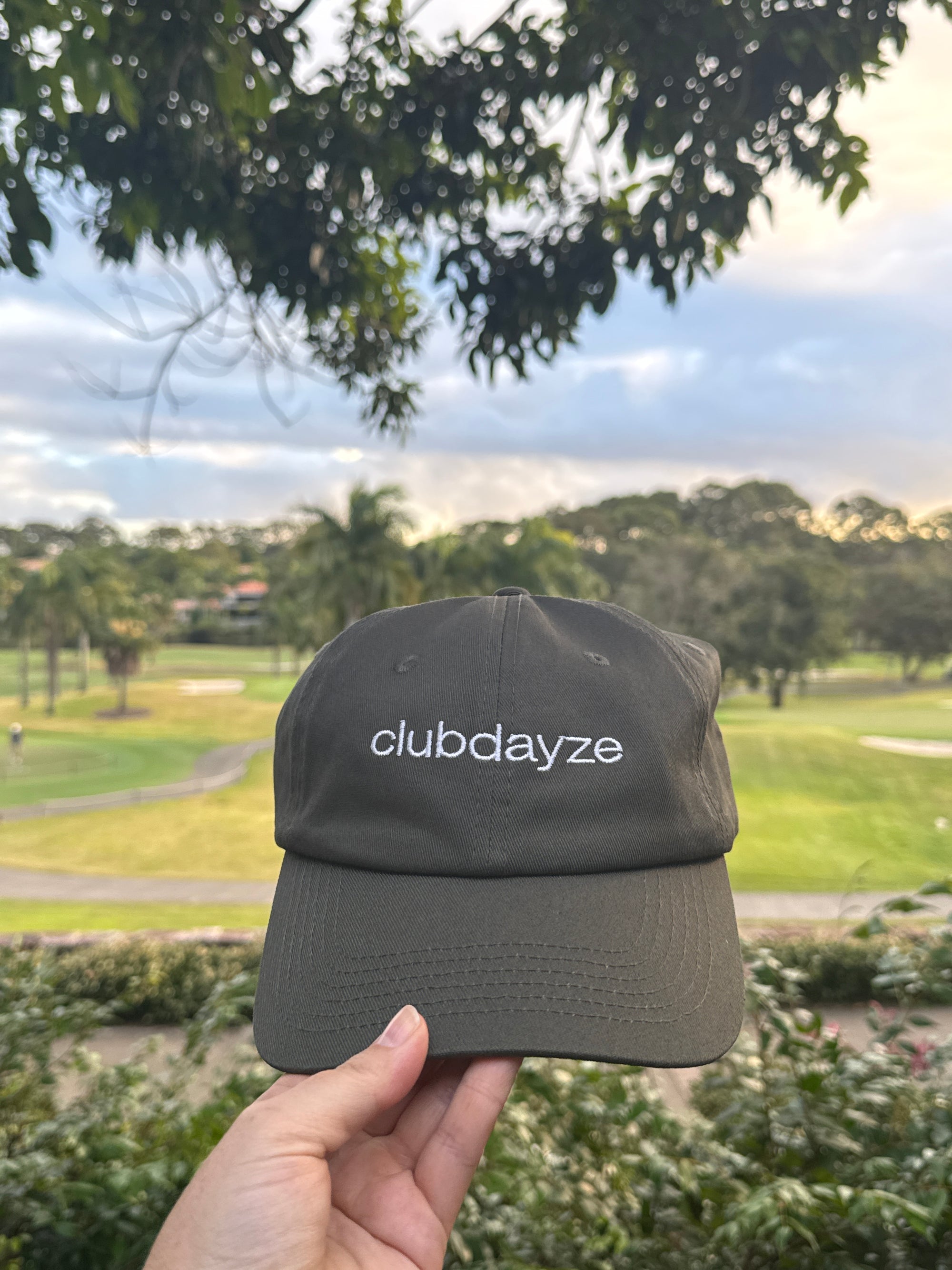Hand holding Clubdayze The Dayze Cap
